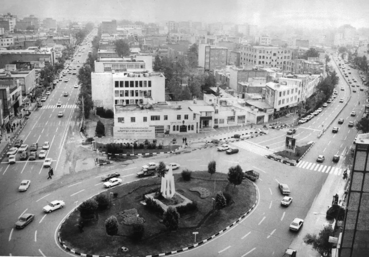 Black and white aerial view of Alborz city with bustling streets and roundabout.